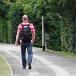 Adult with backpack walking away