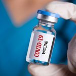 health professional holding COVID-19 vaccine